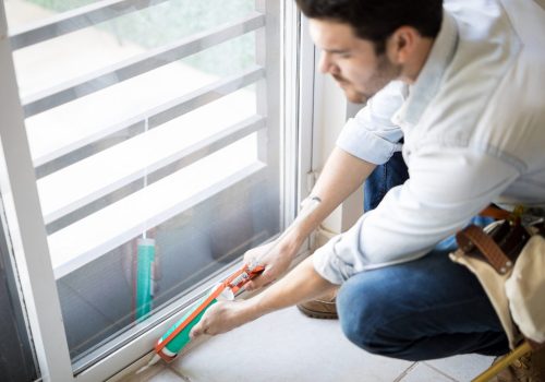 closeup-young-handyman-applying-some-sealant-door-with-sealing-gun-scaled-1.jpg